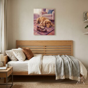 May include: A rectangular wall art print featuring a golden-colored dog lying on a patterned rug with a brown leather shoe between its paws. The dog is positioned in front of a light-colored armchair with a blue cushion in a soft-toned room setting.