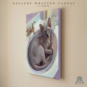 May include: A gallery wrapped canvas with a 1.5 inch depth featuring a painting of a grey hairless cat sitting inside a white bathroom sink with a gold faucet. The artwork displays a feline with large ears and eyes, positioned near a patterned cloth.