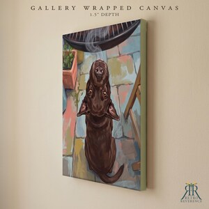 May include: A gallery wrapped canvas with a 1.5 inch depth featuring a painting of a brown dog looking upward at a grill. The scene depicts a stone patio with a potted plant and a wooden chair leg. The text reads GALLERY WRAPPED CANVAS.