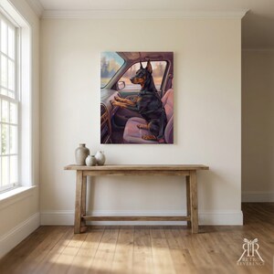 May include: A rectangular wall art print depicting a black and tan Doberman Pinscher sitting in the passenger seat of a car. The dog is wearing a black harness and is positioned with its front paws resting on the dashboard of the vehicle.