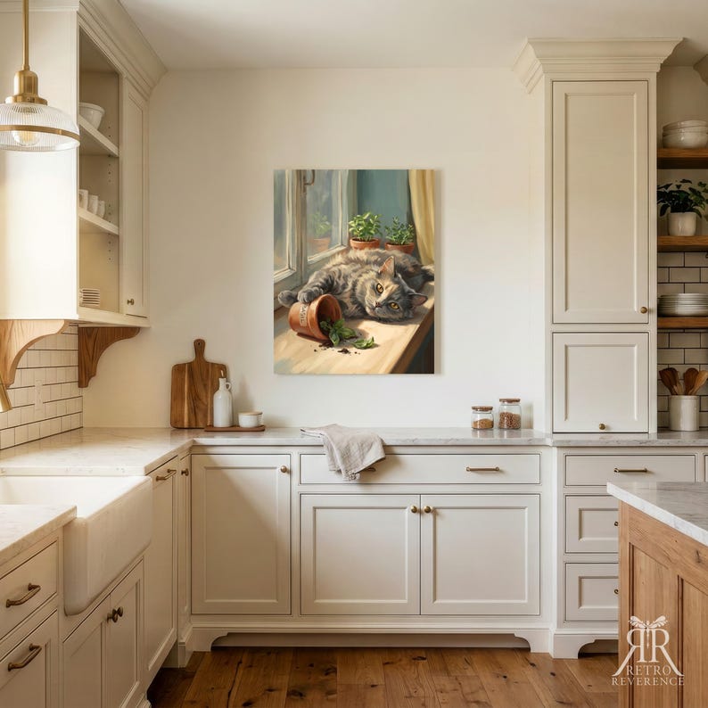 May include: A wall art print depicting a gray tabby cat lying on a windowsill next to a tipped-over terracotta pot with green leaves. The cat rests its head near the spilled soil and plant debris, with two additional potted plants visible.
