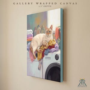 May include: A gallery wrapped canvas with a 1.5 inch depth featuring a digital illustration of a light-colored cat resting on a pile of colorful laundry atop a white washing machine. The scene includes stacked towels, detergent bottles, and a laundry basket.