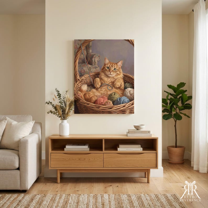May include: A rectangular wall art print featuring an orange tabby cat sitting inside a woven wicker basket filled with various colorful balls of yarn. The cat is looking forward with its paws resting on the yarn. The art is displayed on a wall.