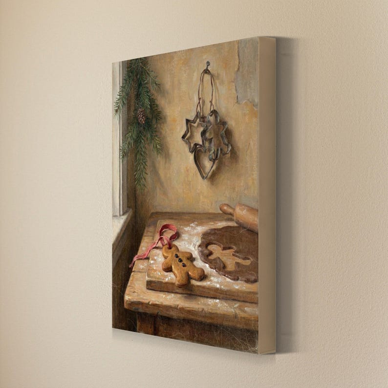 May include: A canvas print featuring an oil painting of a wooden table with a gingerbread man cookie, a rolling pin, and a piece of dough. Metal cookie cutters in star and heart shapes hang on the wall next to a sprig of evergreen.