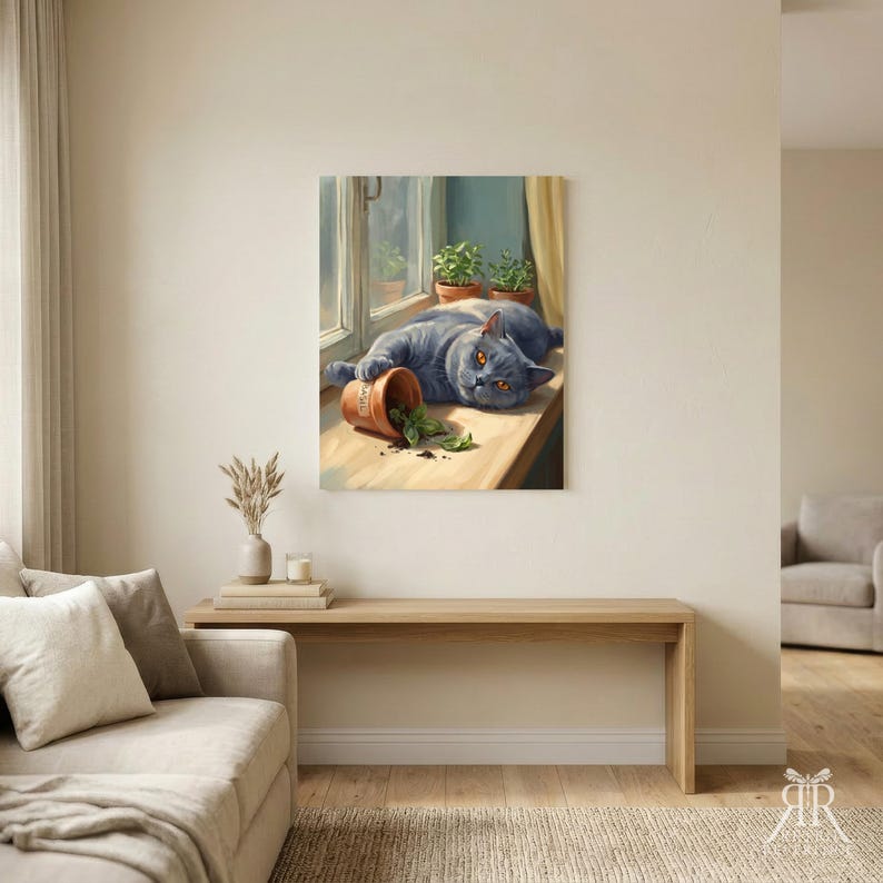 May include: A wall art print depicting a grey cat lying on a windowsill next to a tipped-over terracotta pot with green leaves. Two additional potted plants sit on the sill behind the cat, which has bright orange eyes and a soft coat.