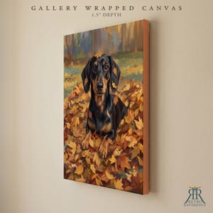 May include: A gallery wrapped canvas with a 1.5 inch depth featuring a painting of a black and tan dachshund sitting in a pile of autumn leaves. The artwork displays the dog surrounded by orange, yellow, and brown foliage in a forest.