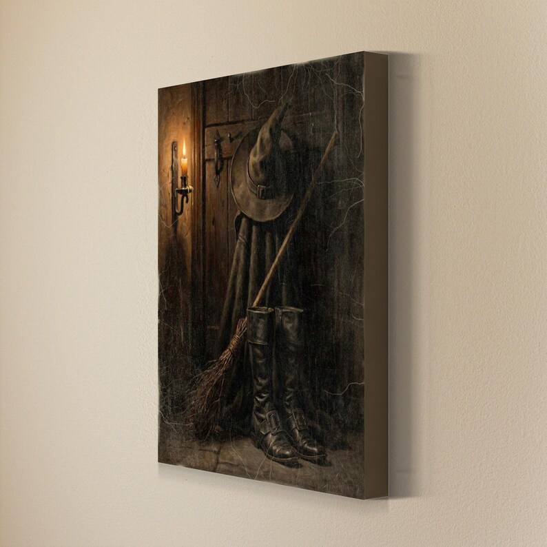 May include: A rectangular canvas wall art print depicting a dark wooden door with a pointed hat, a long cloak, a wooden broomstick, and a pair of black leather boots. A lit candle in a wall sconce illuminates the scene with warm, golden light.