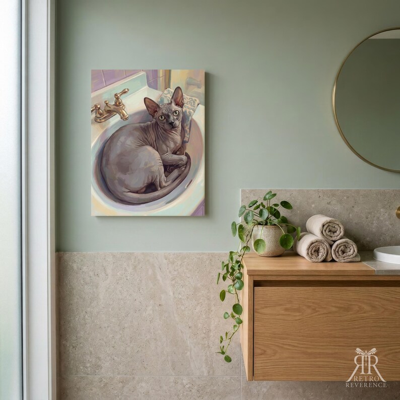 May include: A rectangular wall art print featuring a painting of a hairless Sphynx cat sitting inside a white bathroom sink with a gold faucet. The cat has grey skin and large ears, looking directly forward. The artwork is displayed on a sage green wall.