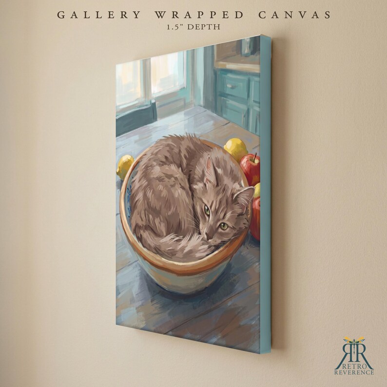 May include: A gallery wrapped canvas with a 1.5 inch depth featuring a painting of a fluffy gray cat curled up inside a ceramic bowl on a wooden table. Beside the bowl are a yellow lemon and a red apple. The text reads GALLERY WRAPPED CANVAS.