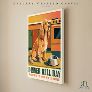 May include: A gallery wrapped canvas with a 1.5 inch depth featuring a golden-colored spaniel sitting in a kitchen next to a metal bowl. The text reads DINNER BELL BAY and PUNCTUAL TO THE SOUND OF A CAN OPENER. The art style uses flat colors.