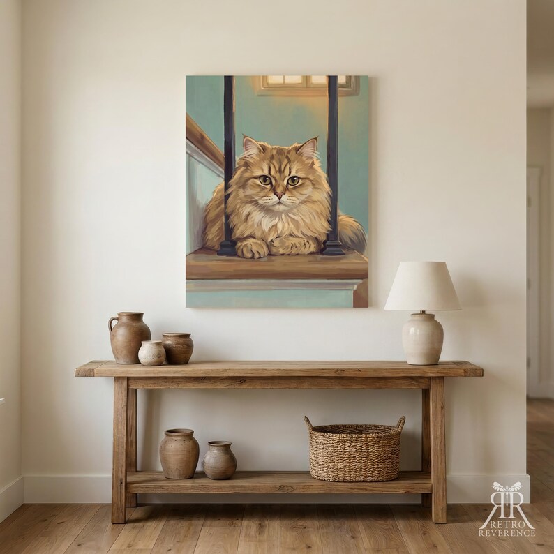 May include: A rectangular wall art print featuring a fluffy golden-brown cat sitting on a wooden staircase landing between dark vertical railings. The painting uses soft light and muted blue tones to depict the feline subject in a calm, seated pose.