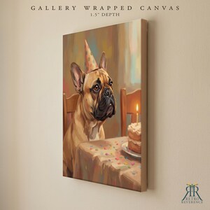 May include: A gallery wrapped canvas with a 1.5 inch depth featuring a tan French Bulldog wearing a colorful party hat. The dog sits at a table with a birthday cake topped with a single lit candle and scattered confetti on the tablecloth.