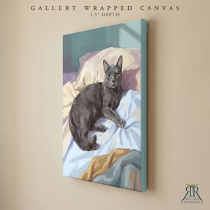 May include: A gallery wrapped canvas with a 1.5 inch depth featuring a digital painting of a grey cat with bright green eyes resting on light blue and cream colored bedding. The text GALLERY WRAPPED CANVAS 1.5" DEPTH appears at the top.