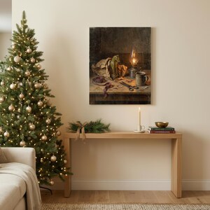 May include: A rectangular wall art print depicting a still life scene with a green toy horse, a lit oil lamp, a ceramic mug, and scissors on a wooden table. The artwork features dark, moody tones and is displayed above a light wood console table.