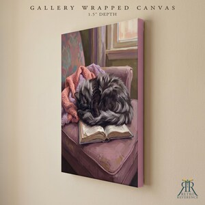 May include: A gallery wrapped canvas with a 1.5 inch depth featuring a painting of a fluffy black cat curled up asleep on an open book. The cat rests on a mauve armchair next to a pink knitted blanket, with a window visible in the background.