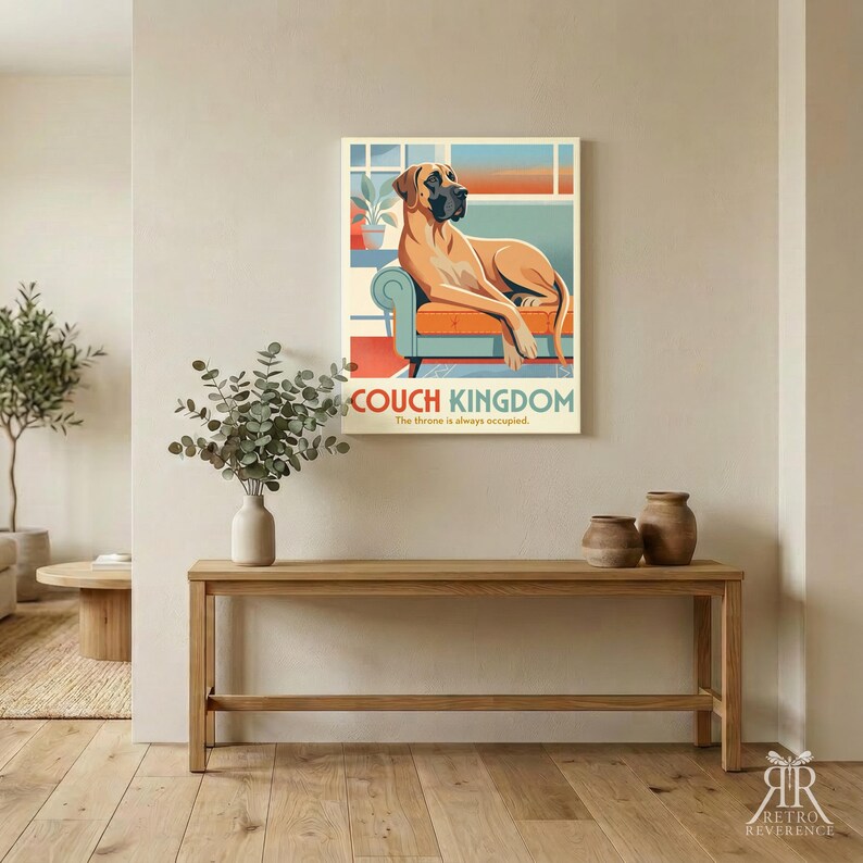 Puede incluir: Una impresi&oacute;n de arte mural rectangular que muestra un gran dan&eacute;s de color canela descansando en un sof&aacute; azul verdoso con cojines naranjas. El texto COUCH KINGDOM y The throne is always occupied est&aacute; impreso en azul y naranja.