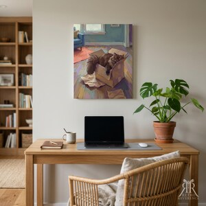 May include: A rectangular wall art print depicting a fluffy dark brown cat resting inside a cardboard box on a wooden floor, with a blue chair and orange rug visible in the background. The artwork features a painterly style with visible brushstrokes.