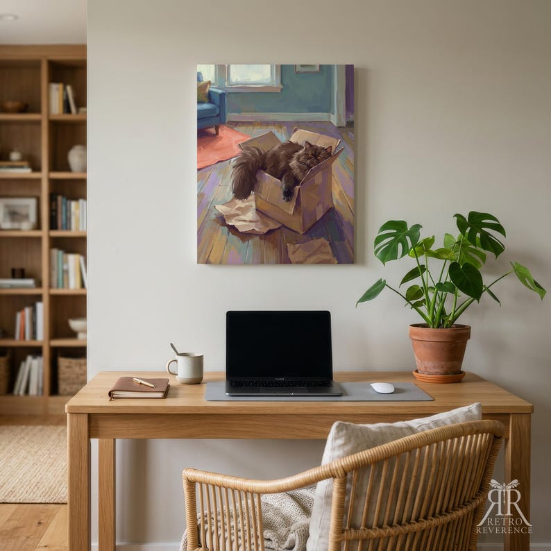 May include: A rectangular wall art print depicting a fluffy dark brown cat resting inside a cardboard box on a wooden floor, with a blue chair and orange rug visible in the background. The artwork features a painterly style with visible brushstrokes.