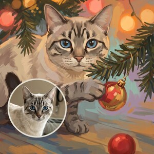 May include: A digital painting of a light-colored tabby cat with blue eyes reaching for a red Christmas ornament hanging from a pine branch. A circular inset shows a realistic photograph of the same cat. Warm, glowing fairy lights are visible.