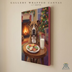 May include: A gallery wrapped canvas with 1.5 inch depth featuring a brown and white dog sitting at a small wooden table. On the table sits a white plate of colorful Christmas cookies and a glass of milk, with a fireplace and tree behind.