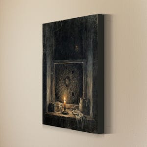 May include: A rectangular canvas print depicting a dark, moody interior scene with a window covered in a large spiderweb. A lit candle in a holder sits on the sill next to a small box and a ceramic pitcher, with a spider visible above the window.