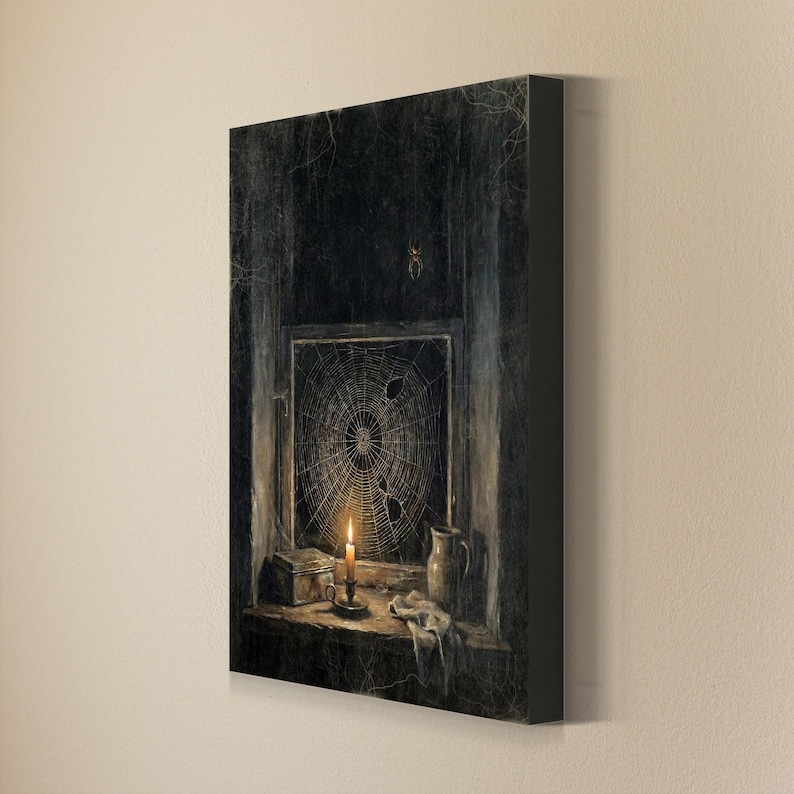 May include: A rectangular canvas print depicting a dark, moody interior scene with a window covered in a large spiderweb. A lit candle in a holder sits on the sill next to a small box and a ceramic pitcher, with a spider visible above the window.
