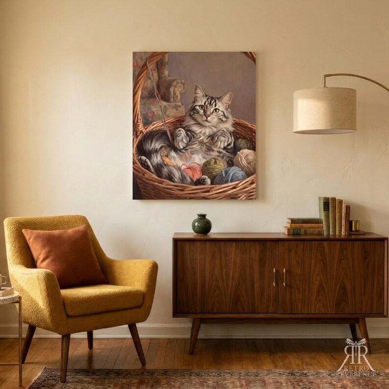 May include: A rectangular wall art print featuring a fluffy grey and white tabby cat sitting inside a woven wicker basket filled with colorful balls of yarn. The cat has green eyes and is looking forward, surrounded by various textured yarn spheres.