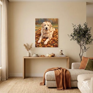 May include: A rectangular wall art print featuring a golden-colored dog lying down in a pile of fallen autumn leaves. The dog has light fur and is positioned centrally, surrounded by orange, yellow, and brown foliage in a forest setting.