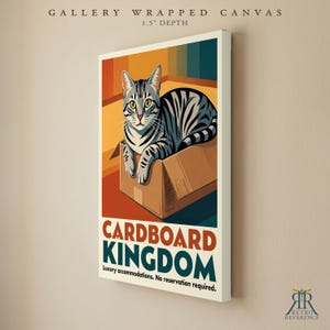 May include: A gallery wrapped canvas with a 1.5 inch depth featuring a gray tabby cat sitting in a cardboard box. The text reads CARDBOARD KINGDOM, Luxury accommodations. No reservation required. The background has orange and teal vertical stripes.