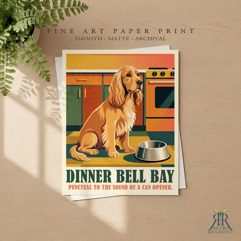 May include: A fine art paper print featuring a golden-brown spaniel sitting in a kitchen with green cabinets and an orange stove. A silver bowl sits on the floor. The text reads DINNER BELL BAY PUNCTUAL TO THE SOUND OF A CAN OPENER.