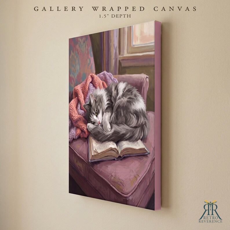 May include: A gallery wrapped canvas with a 1.5 inch depth featuring a painting of a fluffy gray and white cat curled up asleep on an open book. The book rests on a mauve upholstered chair next to a pink knitted blanket, with a window visible in the background.
