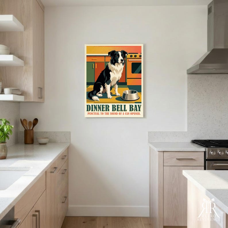 May include: A rectangular wall poster featuring a black and white Border Collie sitting in a kitchen next to a metal bowl. The text reads DINNER BELL BAY and PUNCTUAL TO THE SOUND OF A CAN OPENER. The background shows orange and green kitchen cabinets.