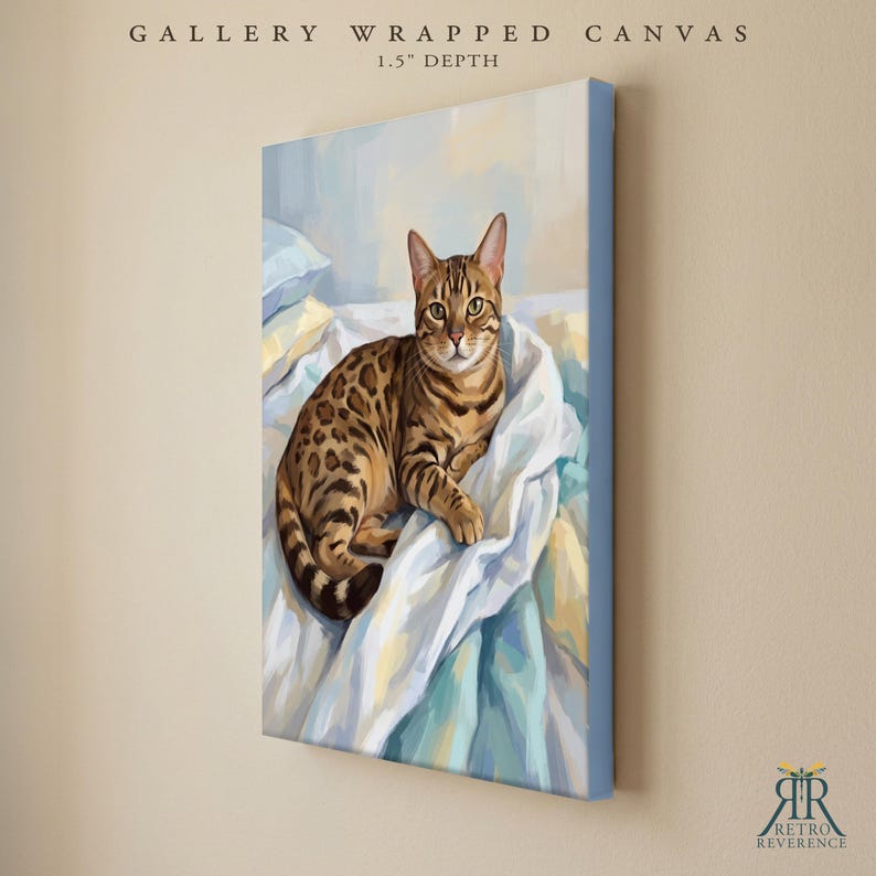 May include: A gallery wrapped canvas with a 1.5 inch depth featuring a painting of a brown spotted Bengal cat resting on white and light blue rumpled bedding. The artwork displays the cat in a seated position with its tail curled.