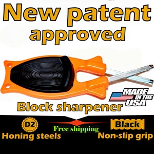 May include: Orange and black block sharpener with two honing steels. The text "New patent approved" is at the top. The text "Block sharpener" and "Made in the USA" are also visible. The sharpener has a black non-slip grip.