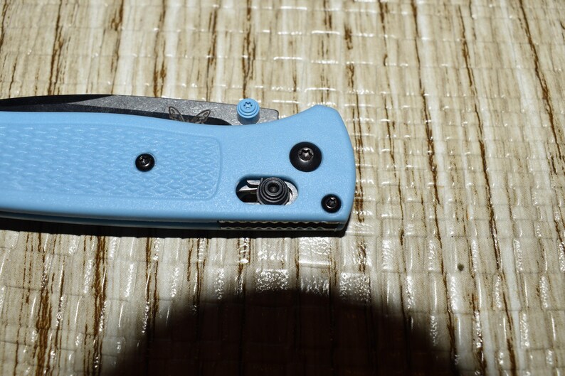 May include: A set of three ceramic mugs with a speckled, matte finish. The mugs are in shades of cream, light gray, and dark gray. Each mug has a simple, minimalist design and a rounded handle.