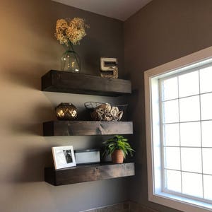 Dark brown wood floating shelves top
