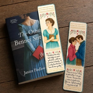 May include: A book titled The Other Bennet Sisters by Janice Hadlow alongside two rectangular bookmarks. One bookmark features a woman in a blue dress holding a book, the other shows a couple embracing, both with floral borders and printed text.