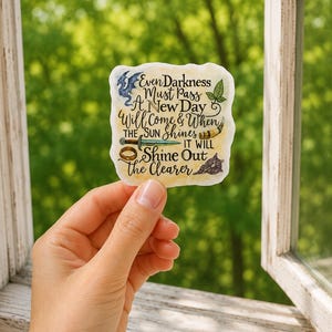 May include: A rectangular sticker with a cream-colored background featuring the black text: Even Darkness Must Pass A New Day Will Come & When THE SUN SHINES IT WILL Shine Out the Clearer. Illustrations include a blue dragon, leaf, sword, ring, and horn.
