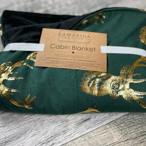 Photo of Hunter Green Majestic Stag blanket from the Kawartha Sign & Pillow Co. Gold Vintage style deer print in gold foil with black chenille backing. Home decor throw blanket