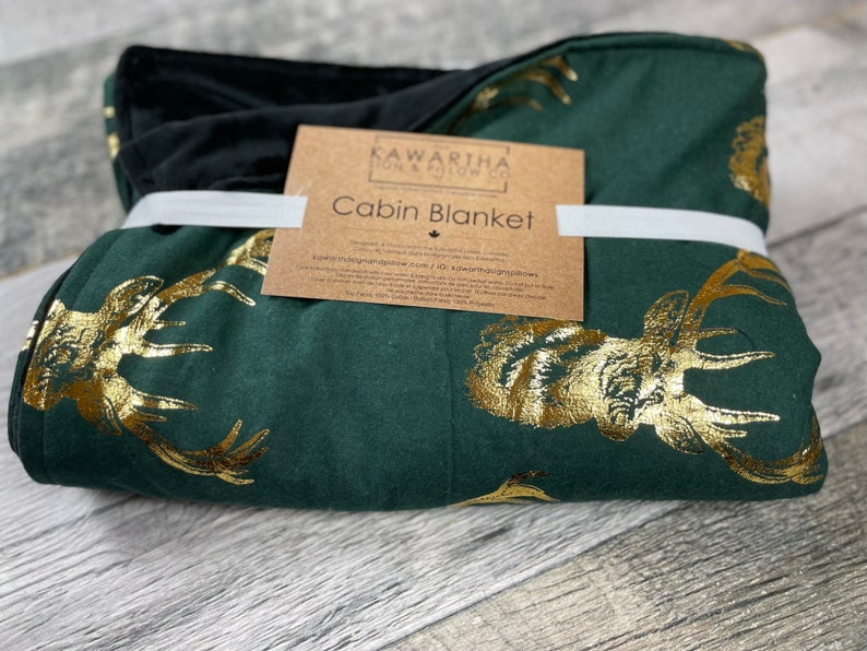 Photo of Hunter Green Majestic Stag blanket from the Kawartha Sign & Pillow Co. Gold Vintage style deer print in gold foil with black chenille backing. Home decor throw blanket
