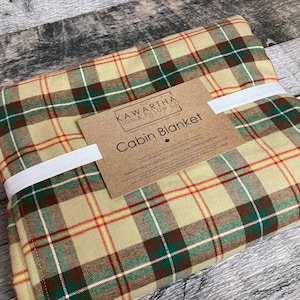 Saskatchewan tartan colour in plaid on cabin throw blanket, Cabin blanket tag on folded blanket