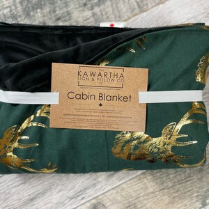 Hunter Green Blanket with gold foil stag print, blanket wrapped with cabin blanket tag from the Kawartha sign & Pillow Co