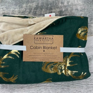 Majestic Stag throw blanket from The Kawartha Sign & Pillow Co. Hunter green blanket with gold foil stag print. Animal print of golden deer on a gorgeous Cabin Blanket from The Kawartha Sign & Pillow Co.