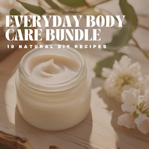 May include: A jar of creamy, off-white body cream. The text "EVERYDAY BODY CARE BUNDLE" and "10 NATURAL DIY RECIPES" are displayed in white. White flowers and green leaves are in the background.