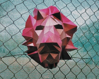 May include: A pink origami lion head sculpture against a blue wire mesh background.