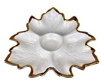 May include: White ceramic serving dish shaped like a leaf with five sections and a gold rim. The dish has a raised leaf design.