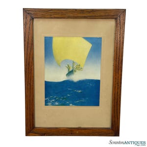 May include: Framed vintage print depicting a sailboat with a yellow sail on blue water. The artwork features a light blue sky and a wooden frame. The print is a vintage piece, likely from the mid-20th century.