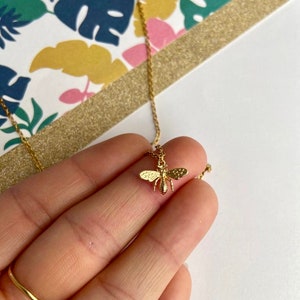 Tiny brass bee necklace