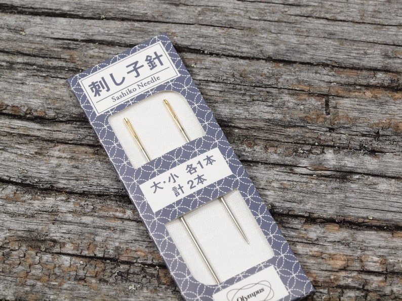 May include: A package of two sashiko needles, one large and one small. The package is blue with white text that reads "Sashiko Needle" and "大・小 各1本 計2本".