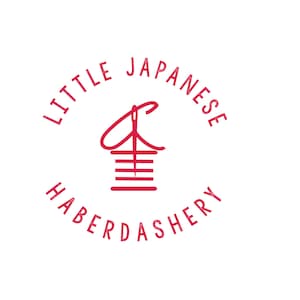 May include: A red logo with the text "Little Japanese Haberdashery" in a circle. The logo features a stylized image of a needle and thread.
